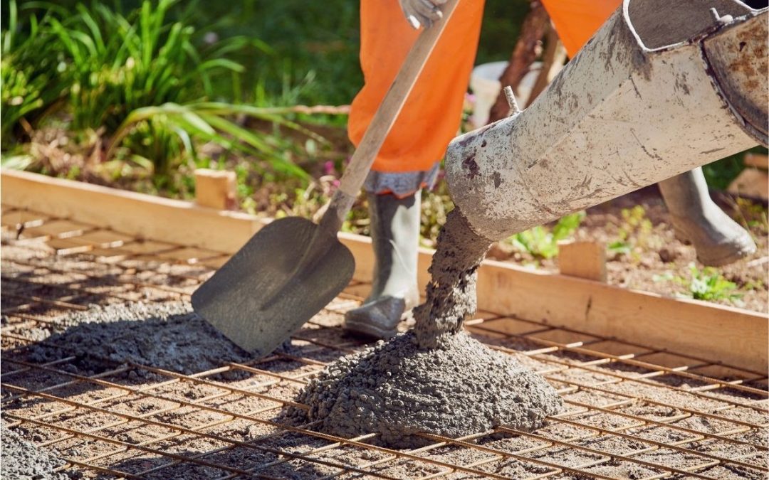 A construction worker wondering about the difference of concrete vs. cement.