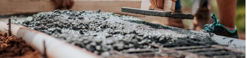 A construction worker making a concrete mixture.